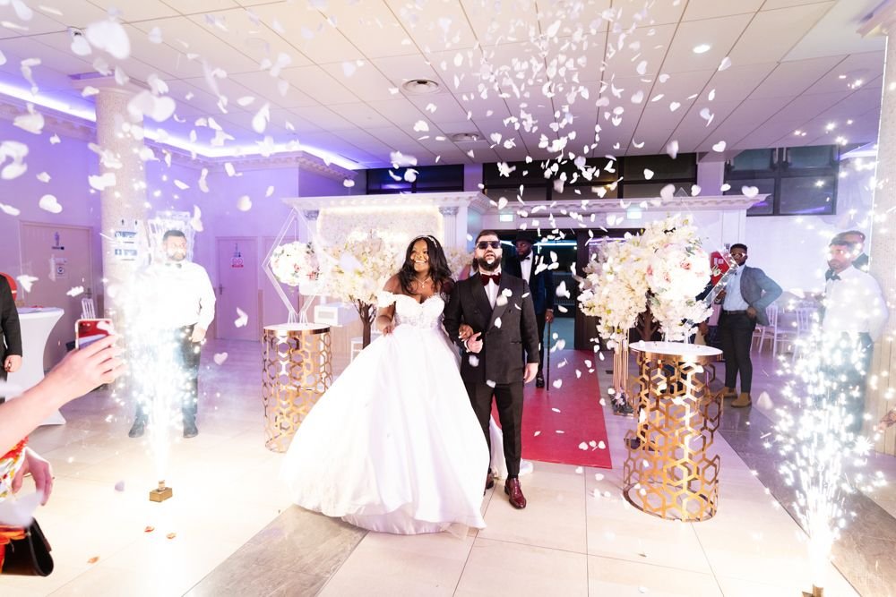 Les mariés entrent dans la salle de réception sous les confettis et les étincelles